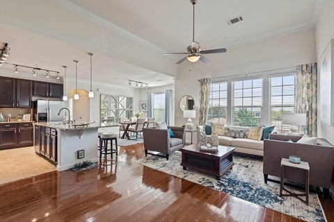 a living room and kitchen with a couch and a table